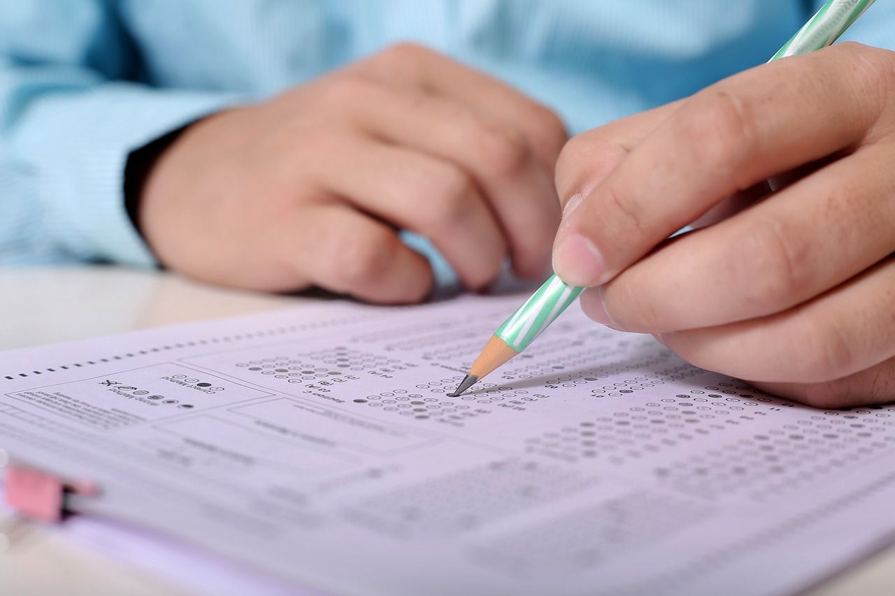 Man with pencil and scantron writing exam