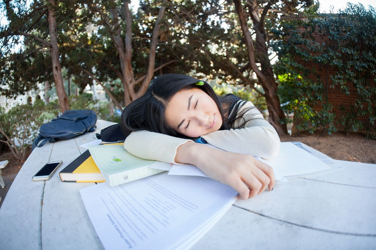 Girl sleeping on table tired from studying