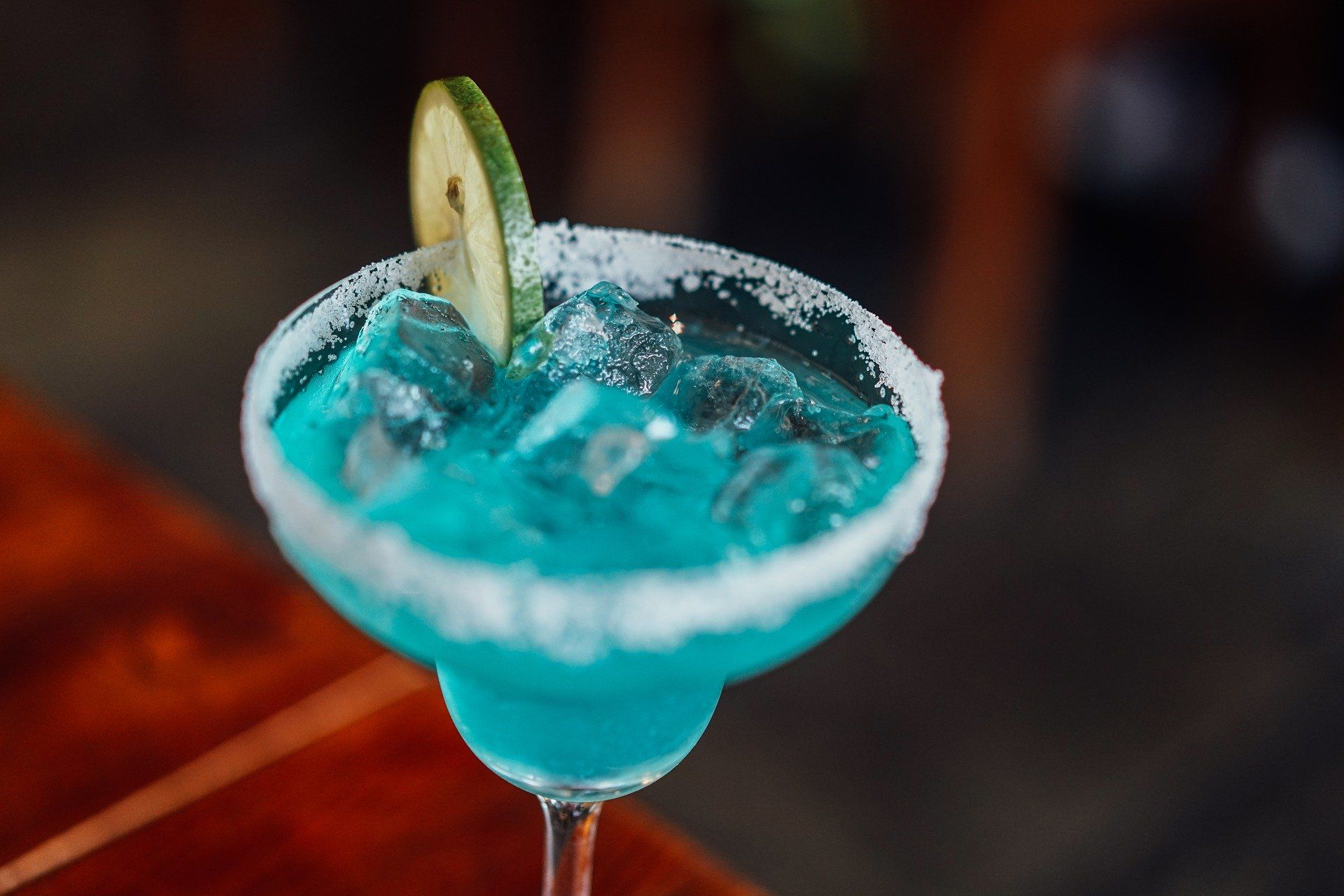 Blue cocktail with a lime wedge