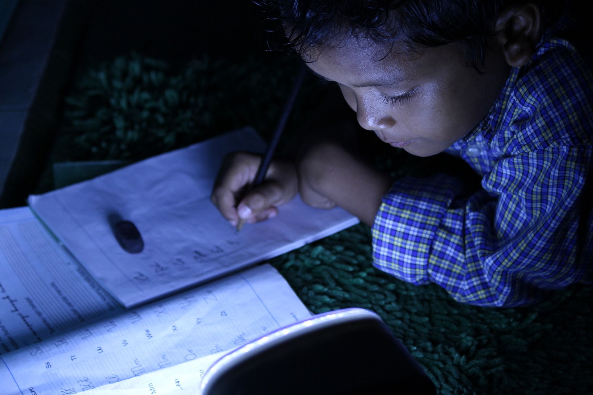Child studying under the lights
