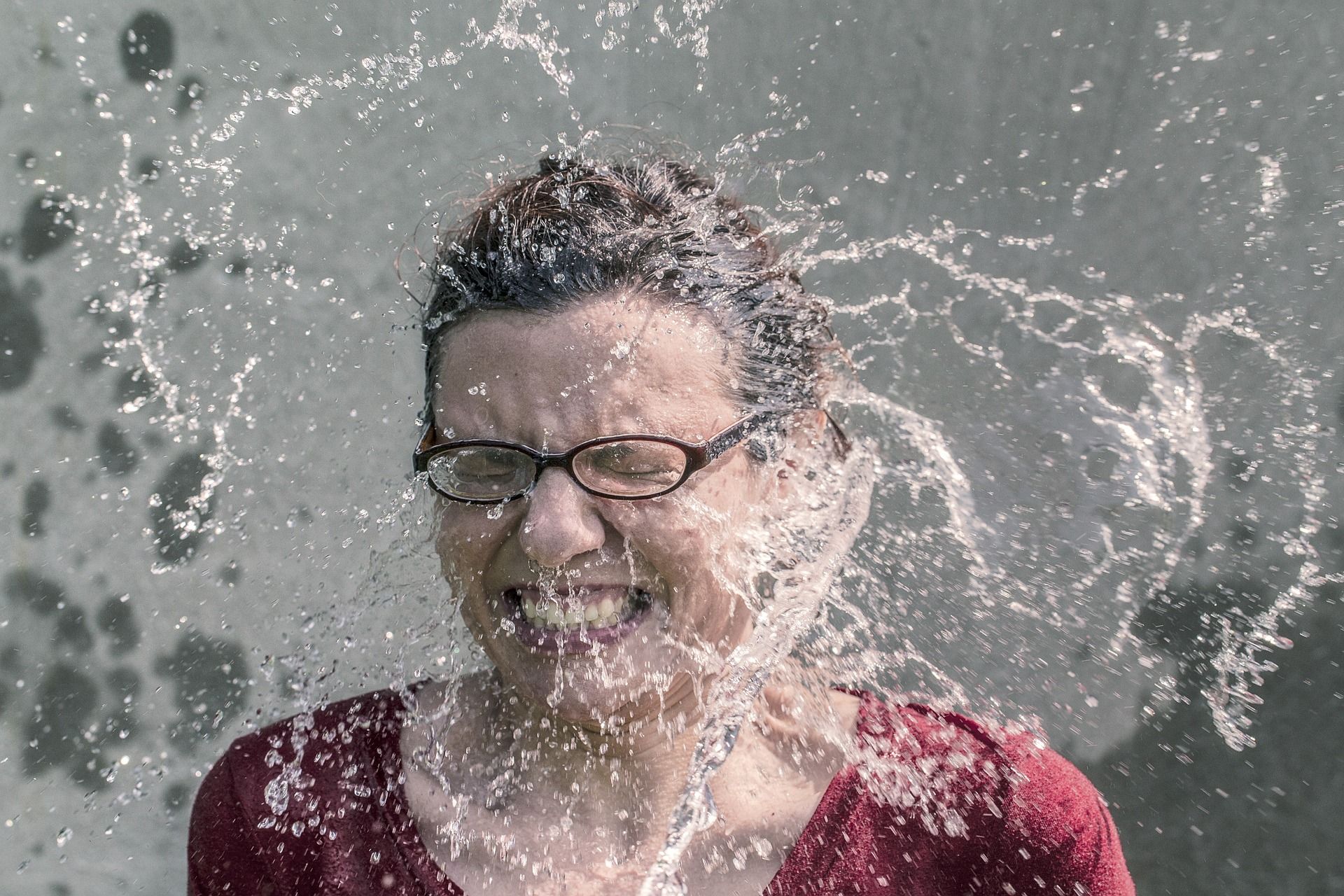 Lady getting splashed with water in the face