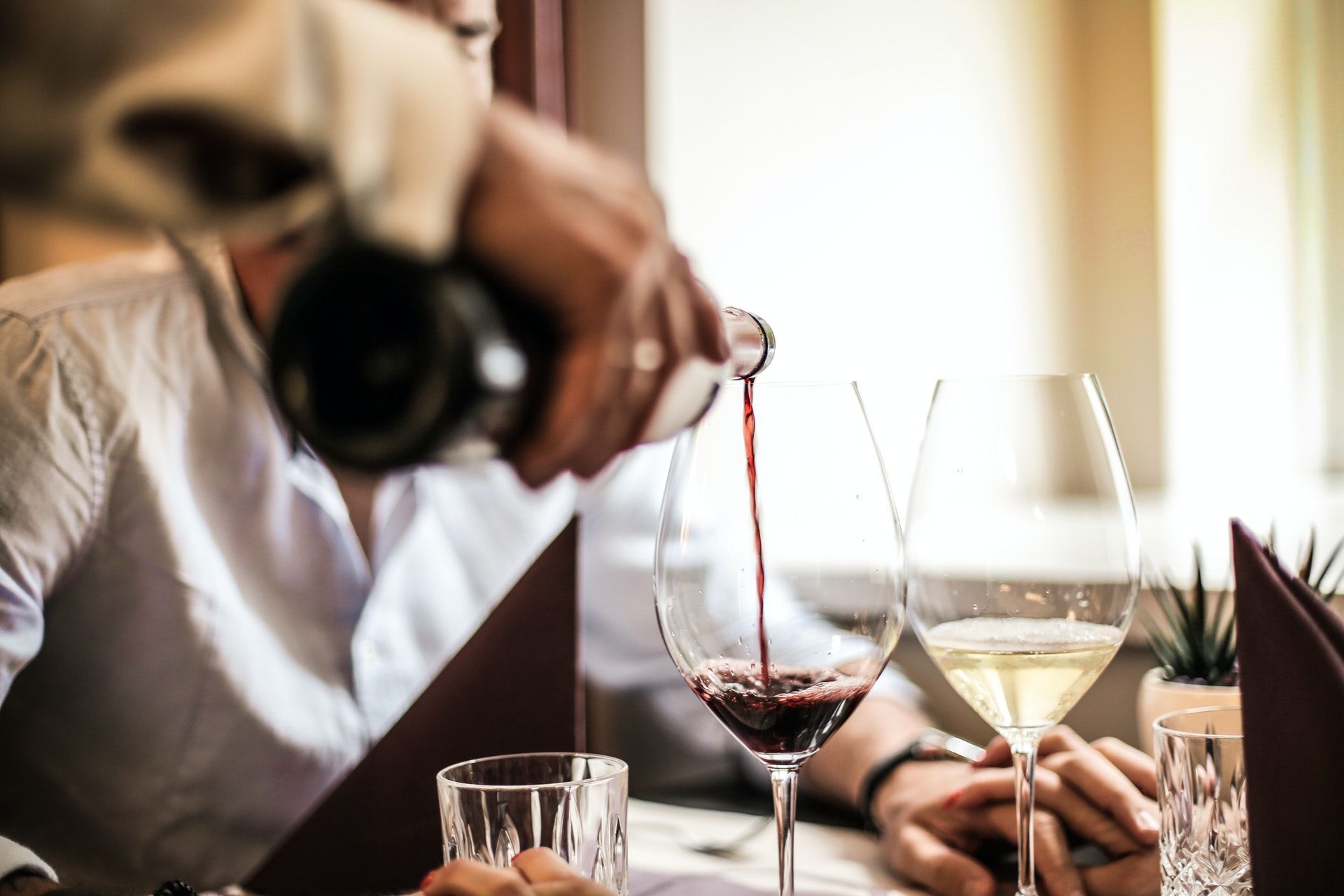 Sommelier pouring wine; WSET Level 3 exam