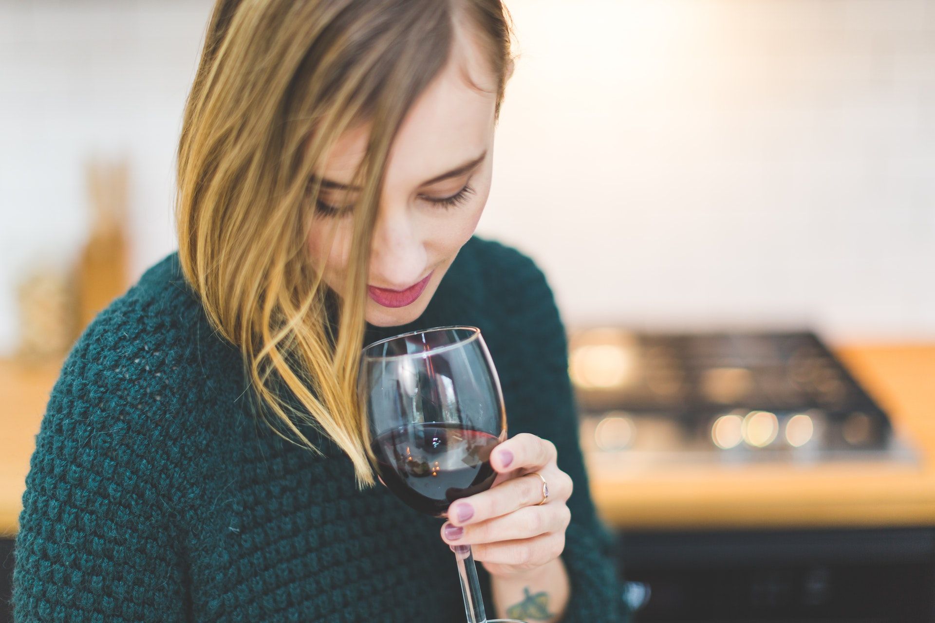 Woman with glass of red wine; WSET Level 1 exam
