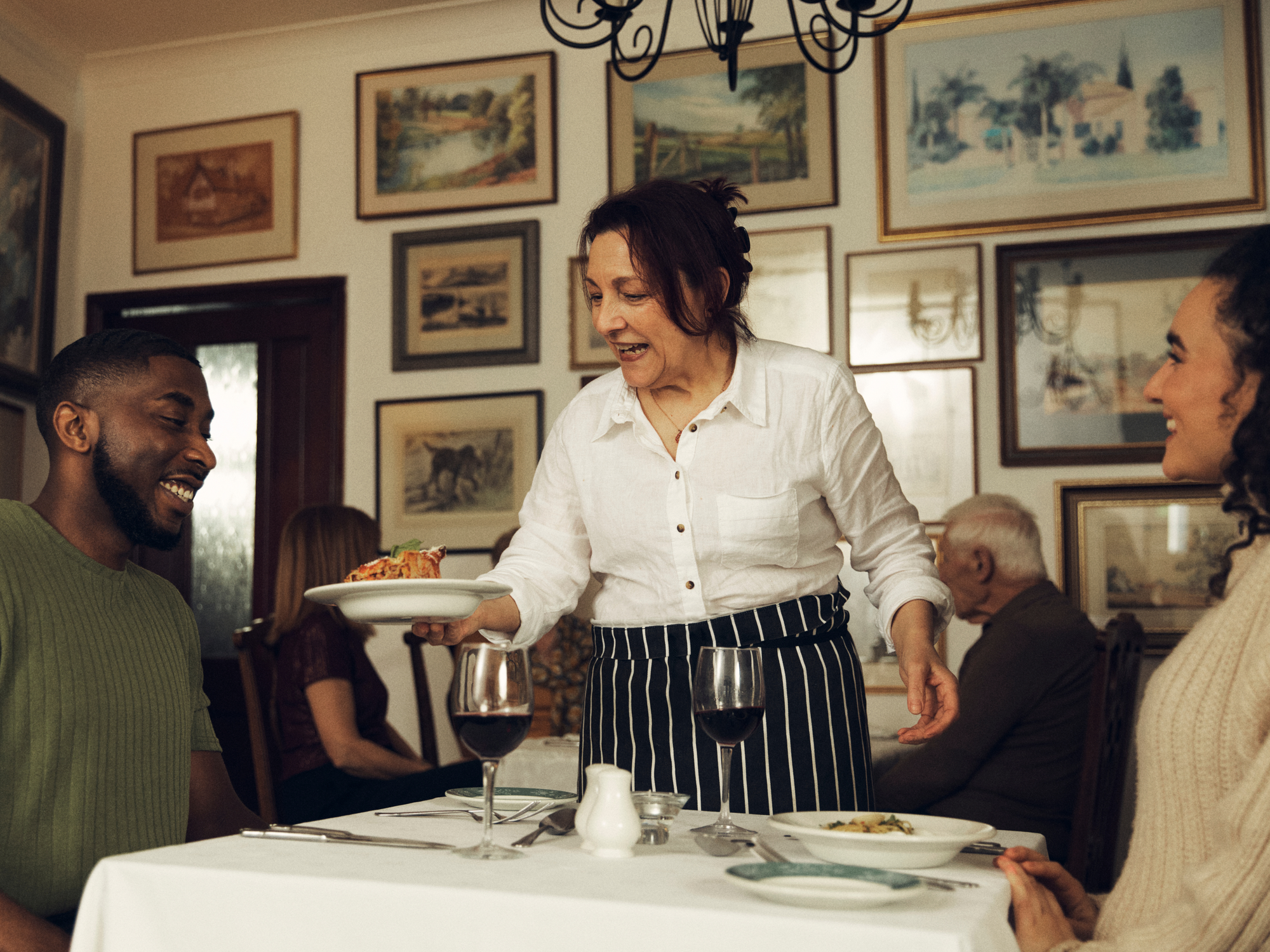 Italian lady serving food in an Italian restaurant