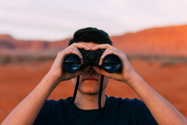 Man looking through binoculors